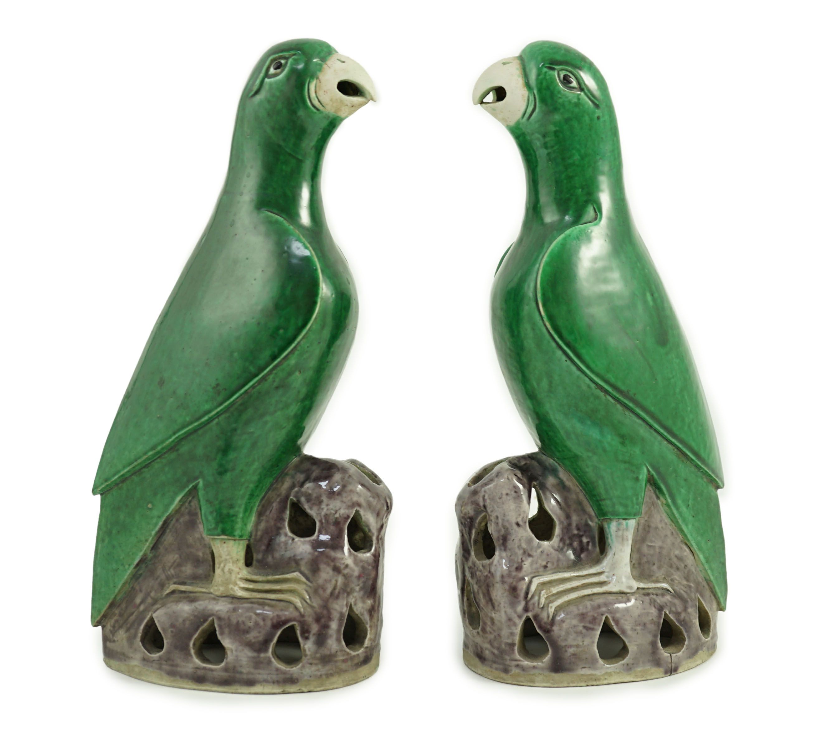 A pair of Chinese green and aubergine glazed models of parrots, 19th century, 27.5cm high